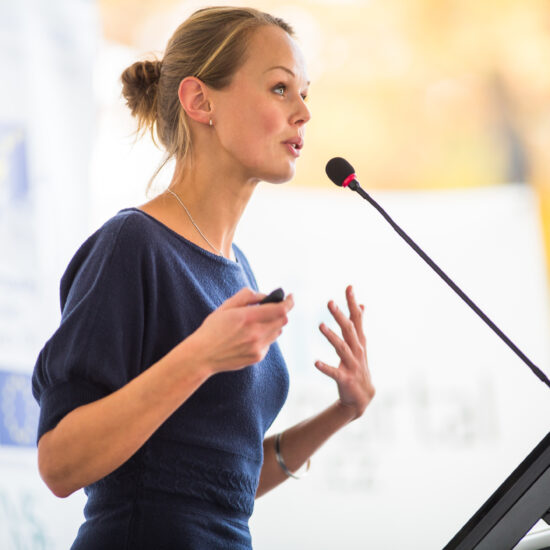 Business woman giving a presentation in a conference/meeting setting
