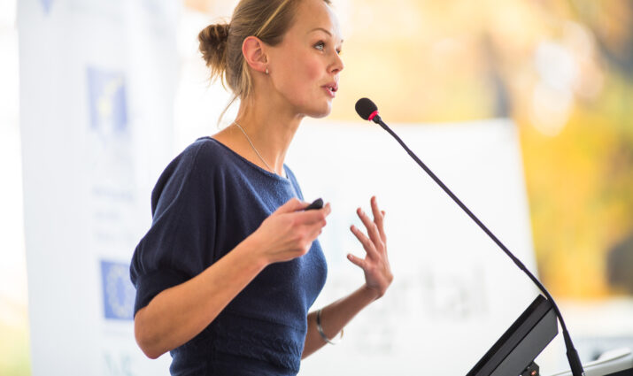 Business woman giving a presentation in a conference/meeting setting
