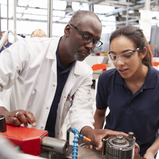 Engineer showing equipment to a female apprentice