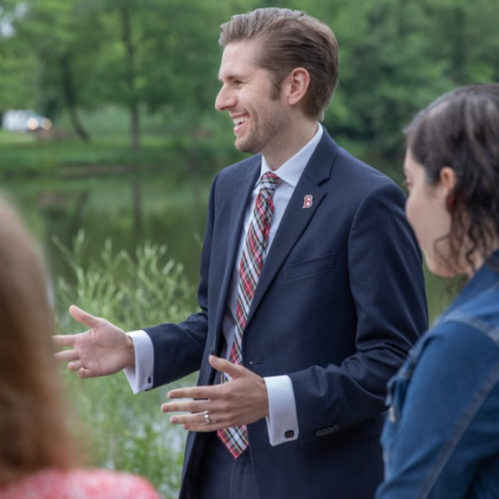 Alumni speaking with students outside