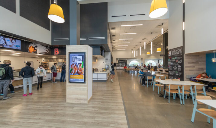 Photo of Benny's cafeteria from the entrance, tables and the food line are visible; dining services