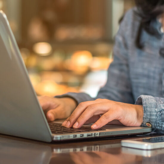 female typing on laptop