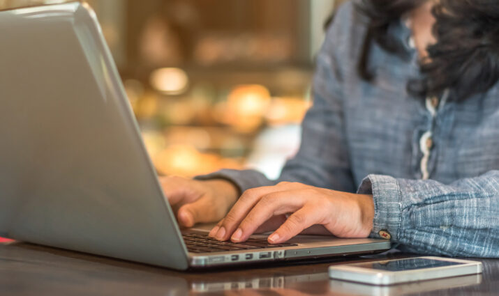 female typing on laptop