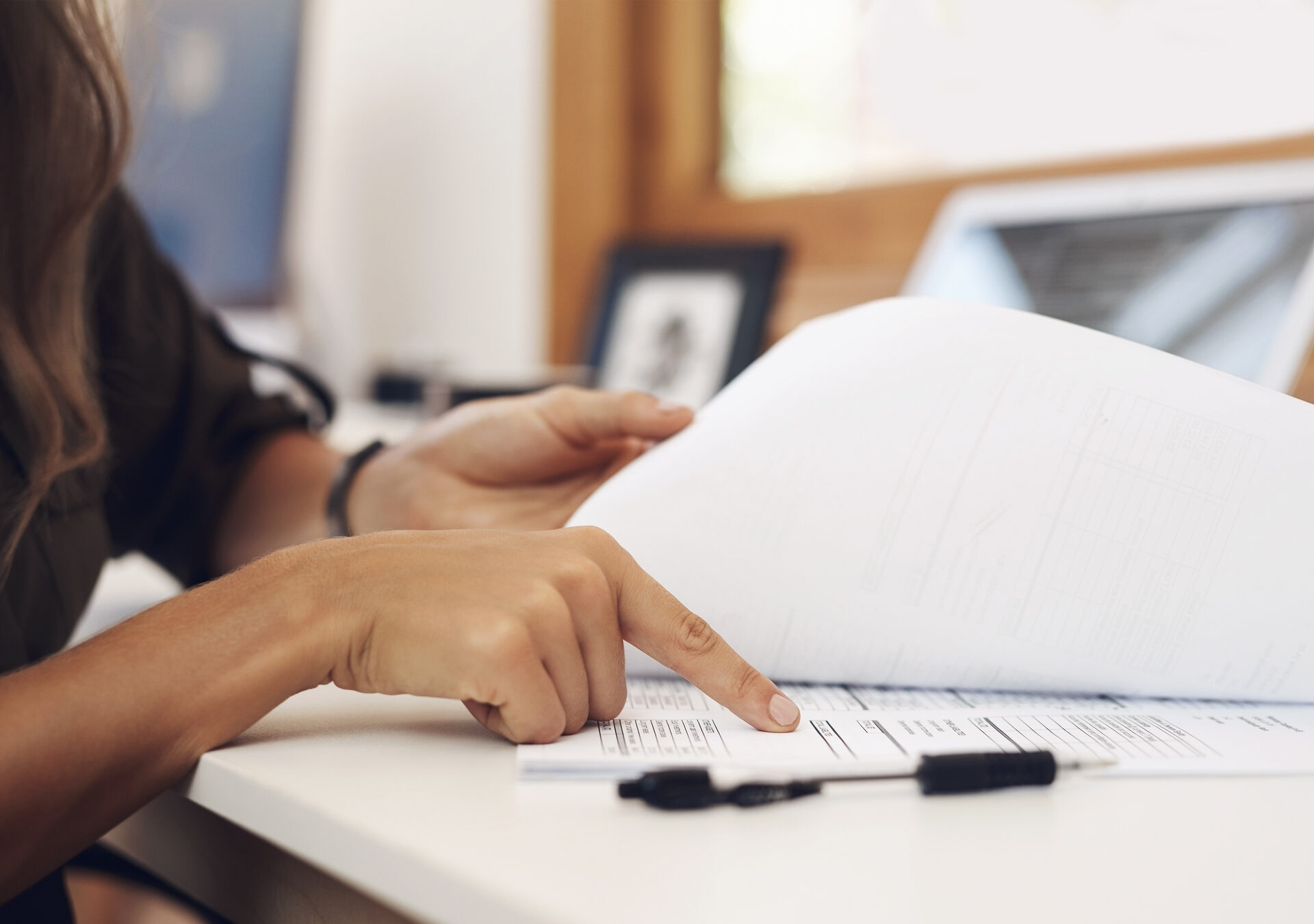 Closeup shot of an unrecognisable businesswoman going through paperwork in an office