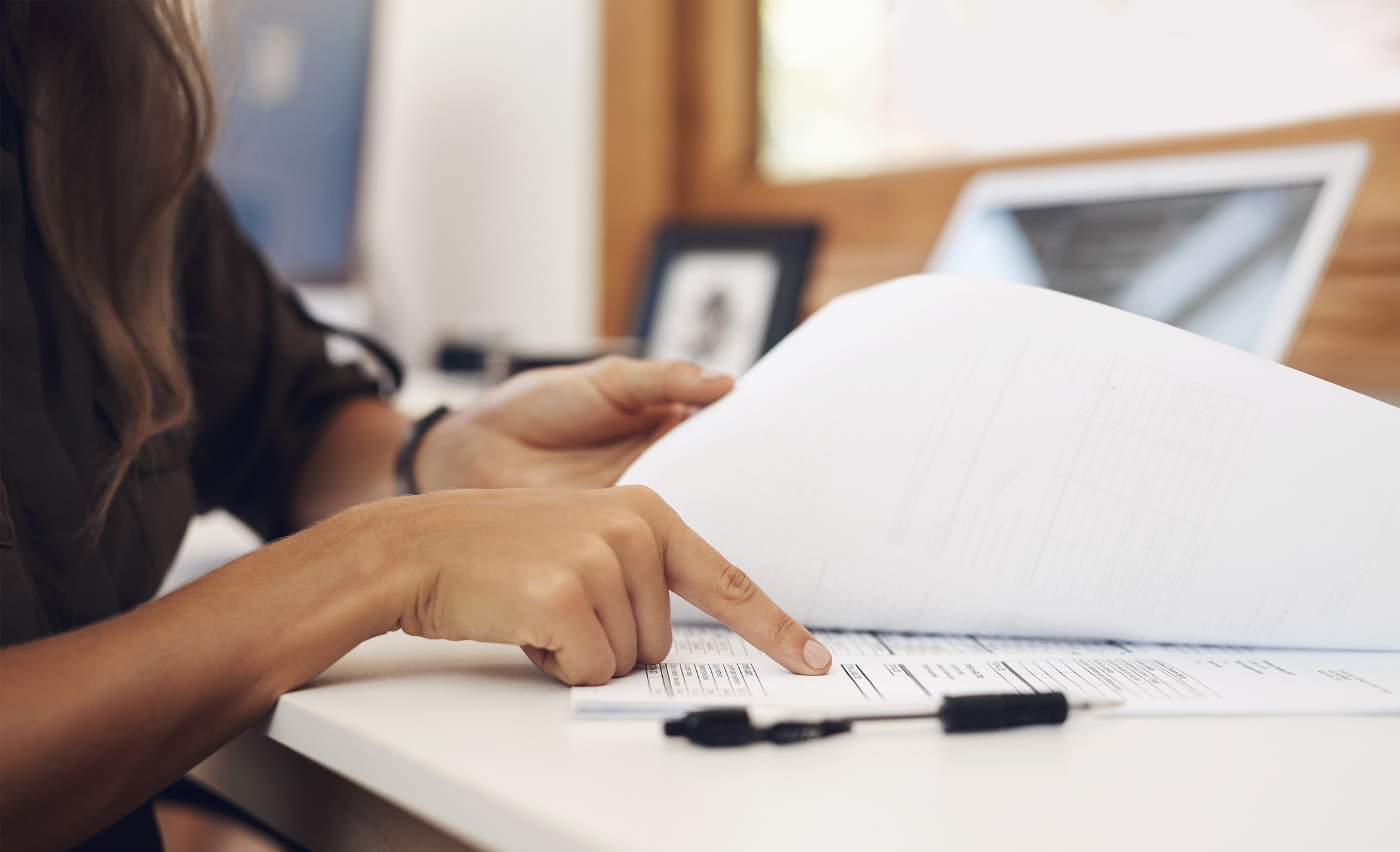 Closeup shot of an unrecognisable businesswoman going through paperwork in an office