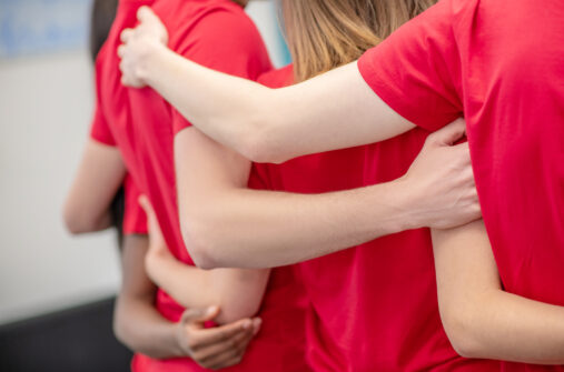 students with arms locked around each other's backs