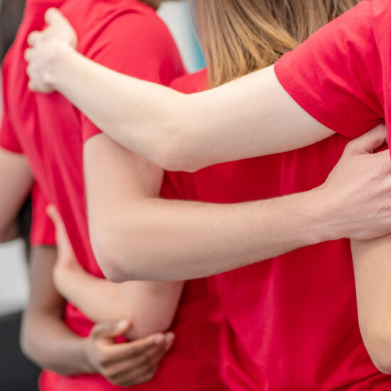 students with arms locked around each other's backs