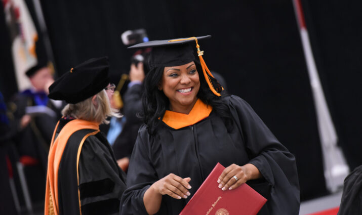female student with degree in hand