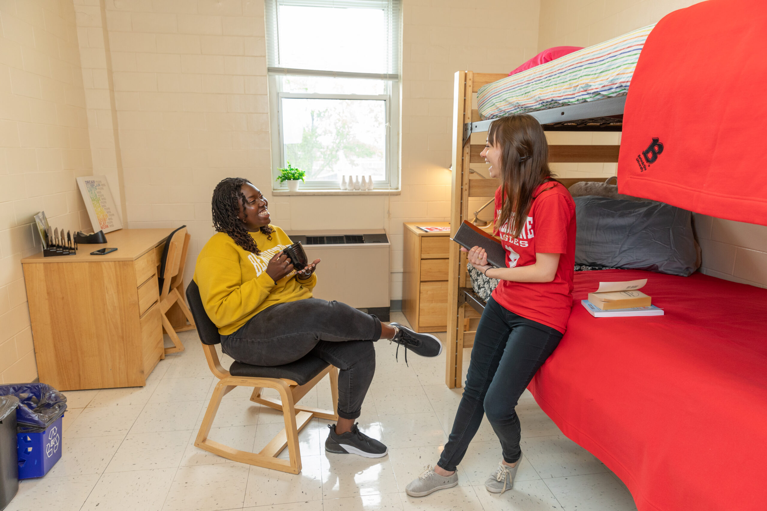Female students laughing in their dorm room