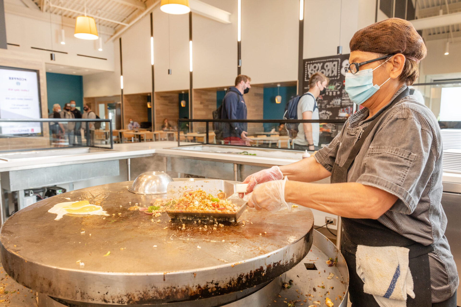 Gloria preparing food in Benny's cafeteria
