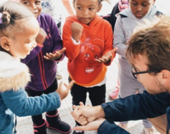 male student with little local children