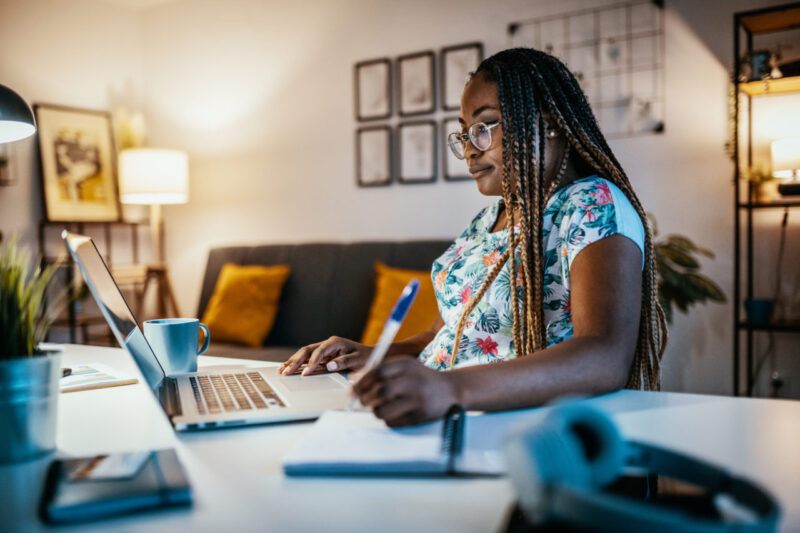 African American female student studying from home on laptop
