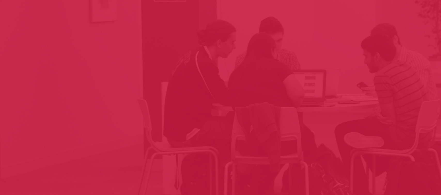 Group of students in the library studying at a table, Photo has red overlay on it