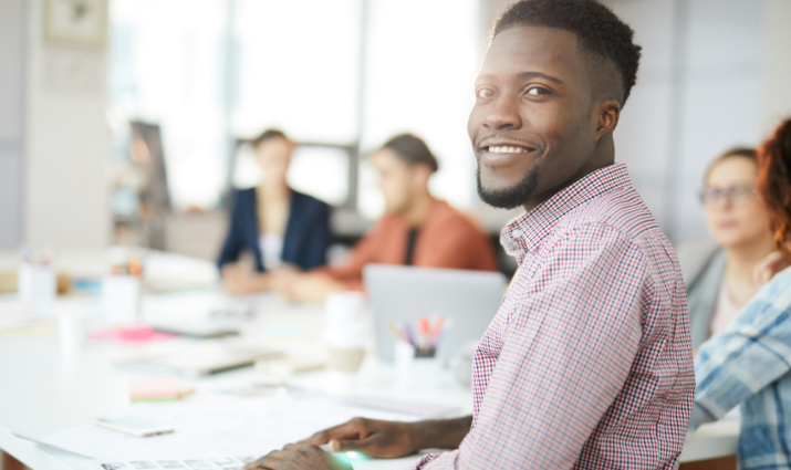 male student at table in group discussion