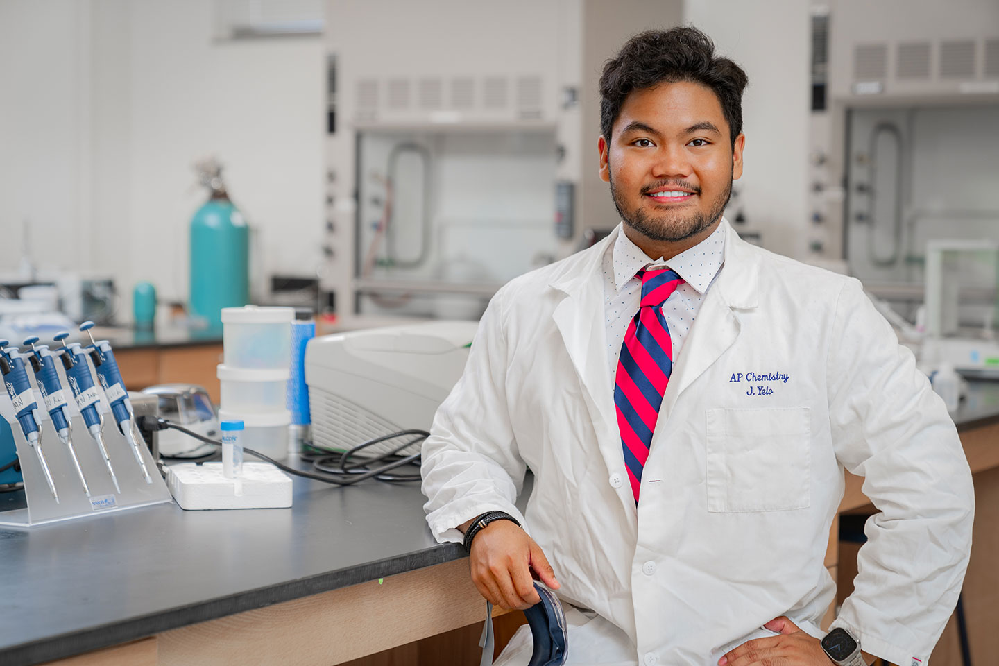 AP chemistry student in lab coat in lab