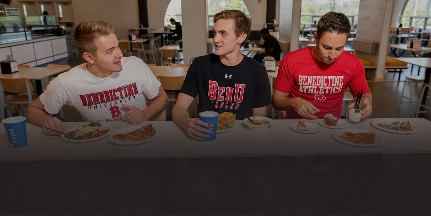 male student eating at Benny's, the student cafeteria on Lisle's campus