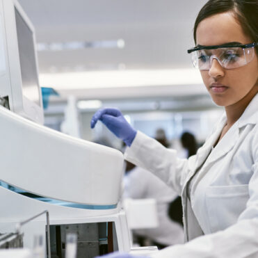 Female medical technologist using equipment - allied health programs