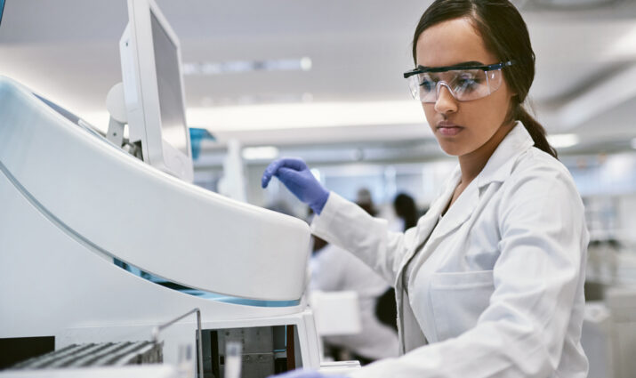 Female medical technologist using equipment - allied health programs