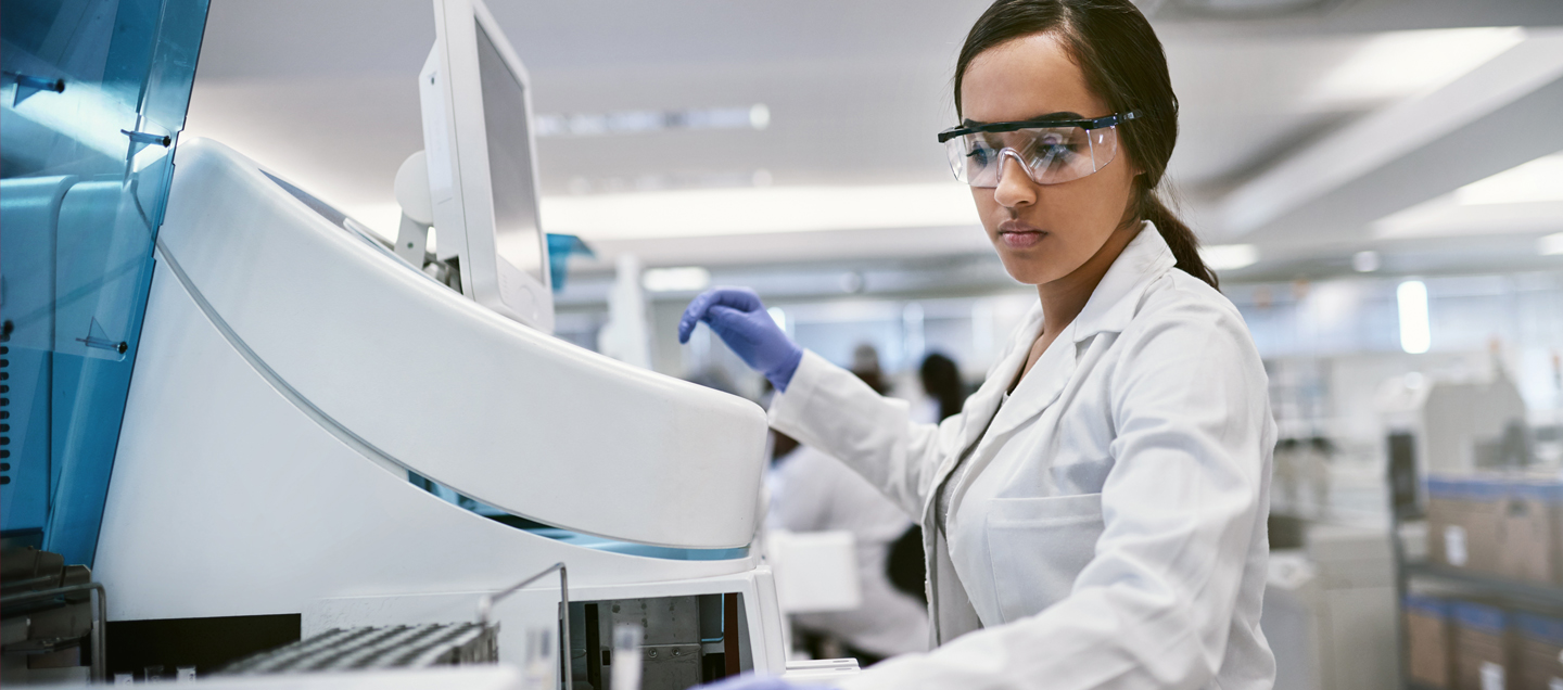 Female medical technologist using equipment - allied health programs