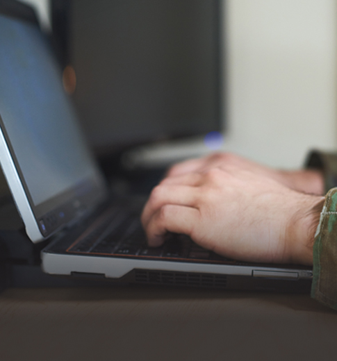 close of up hands typing on a laptop benefits