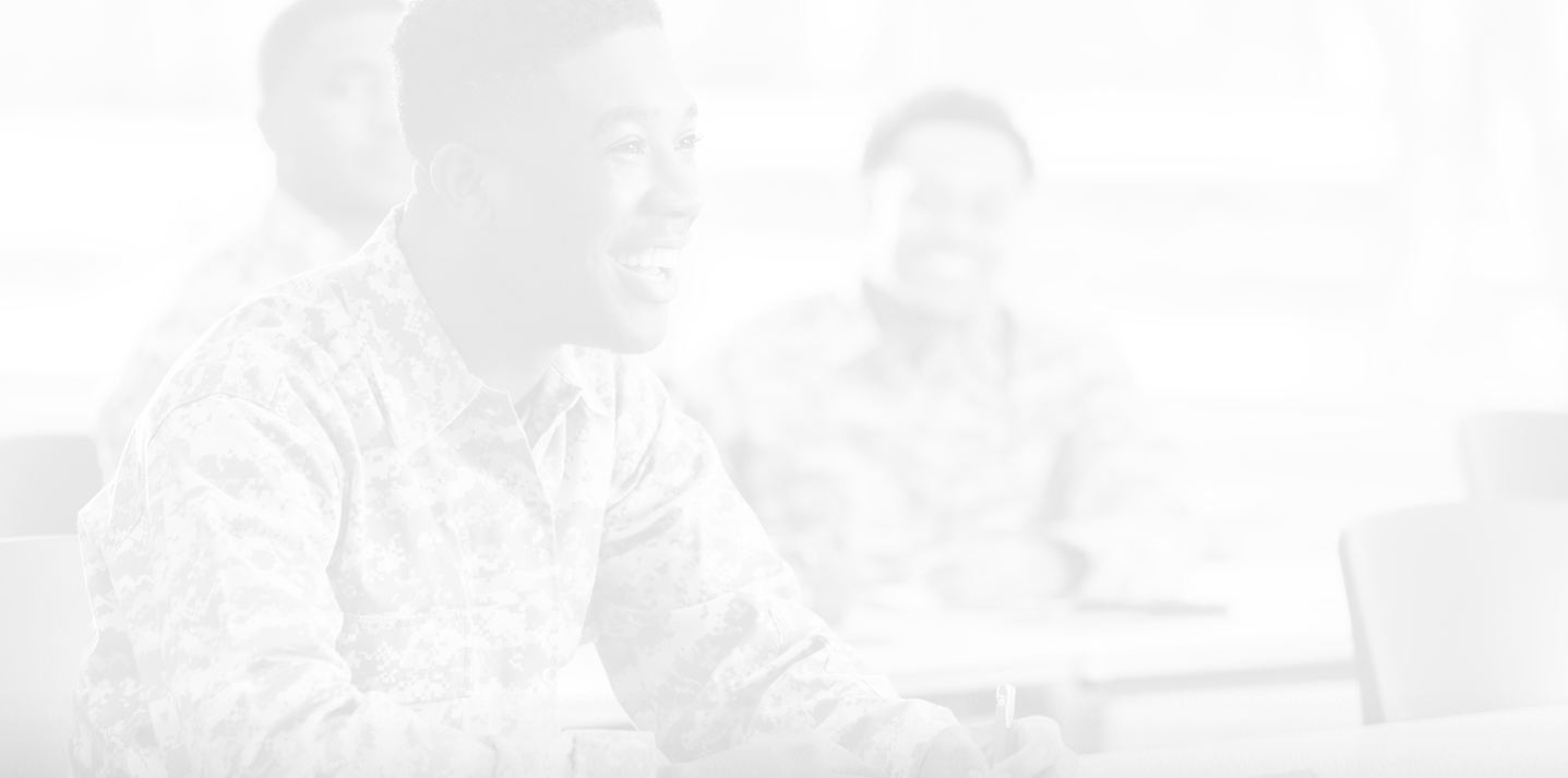 male military student smiling in classroom setting; photo has light gray overlay on it