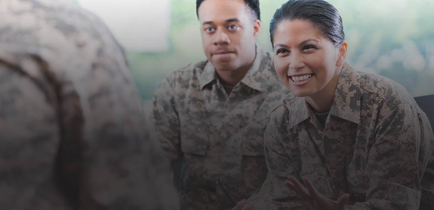 Male and Female military personnel looking at another person; BenU's Yellow Ribbon program