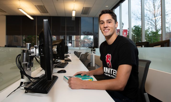 Male student in Goodwin Trading Lab