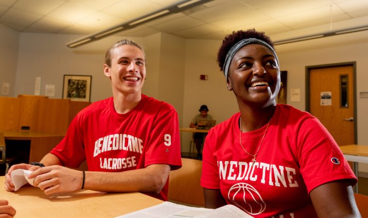 Male and female students in the library