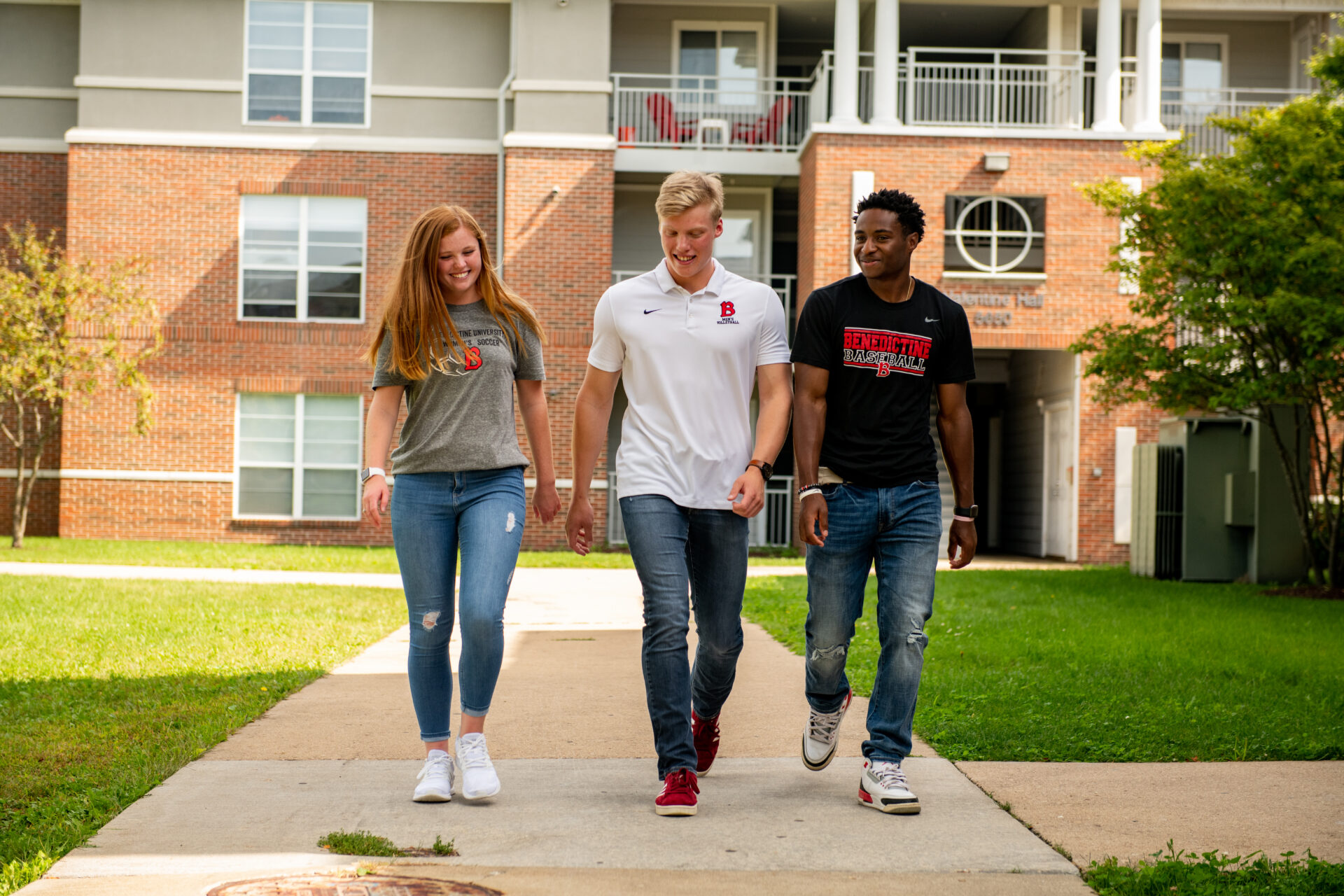 Students walking outside campus apartments