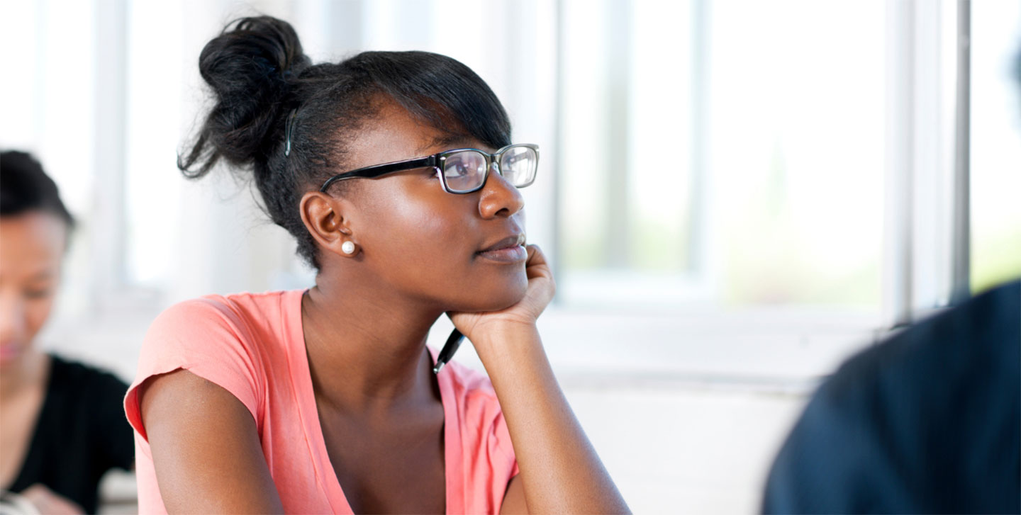 female student leaning her head on her hand listening to lecture; biochemistry, molecular biology