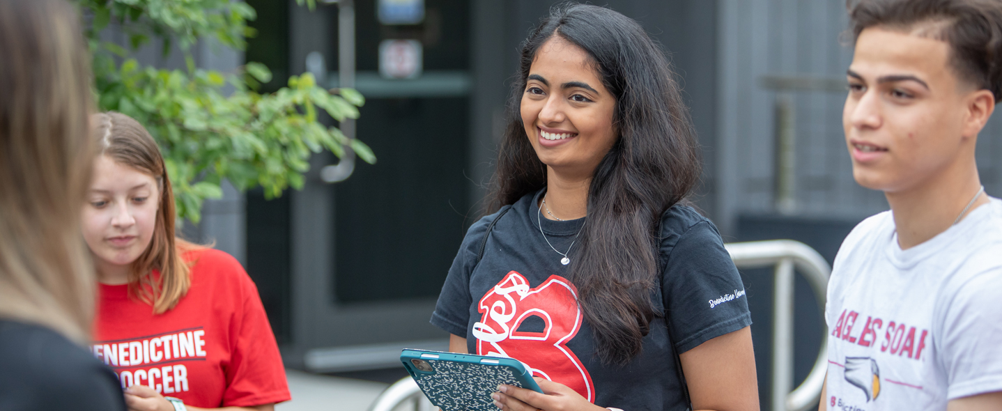 Asian female student smiling holding iPad - financial aid scholarships