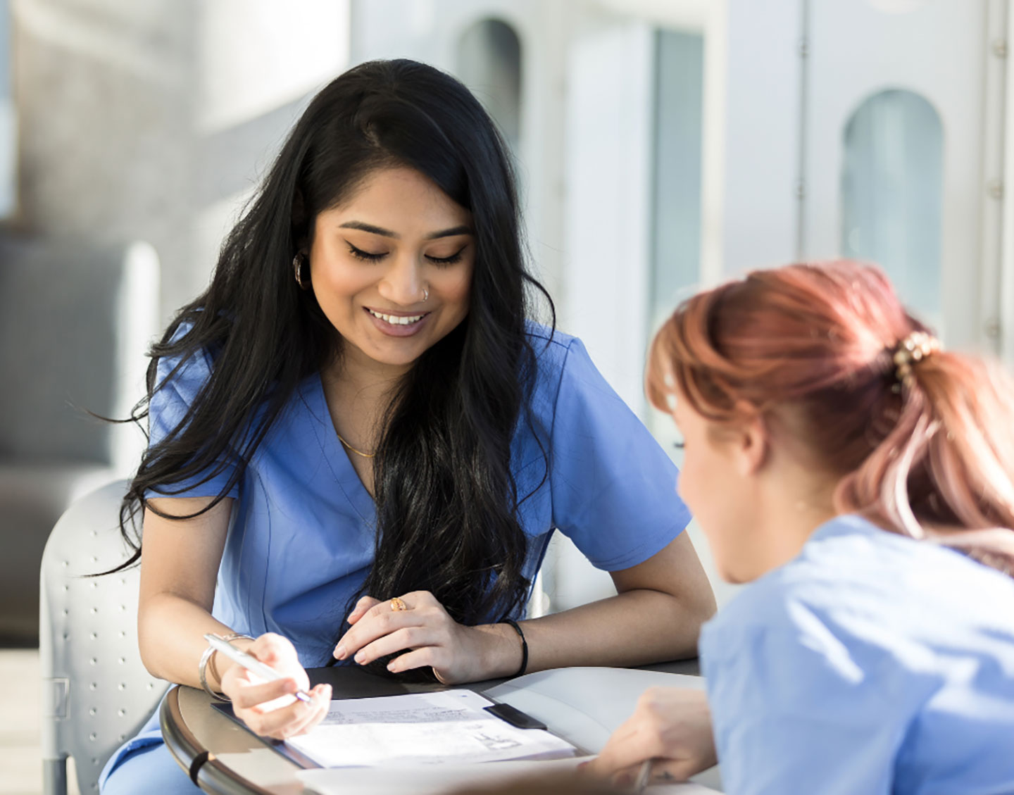 Female pre-professional student studying with another student