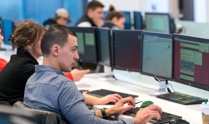Male student in Trade Lab working on the computer, business, analytics