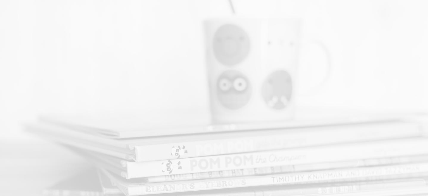 stack of children's books in front of a mug with smiley faces on it, image has white overlay; special education