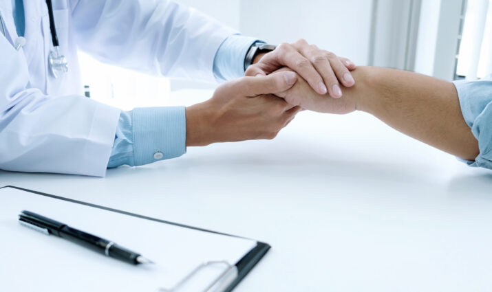 pre-medicine, doctor holding patient hand