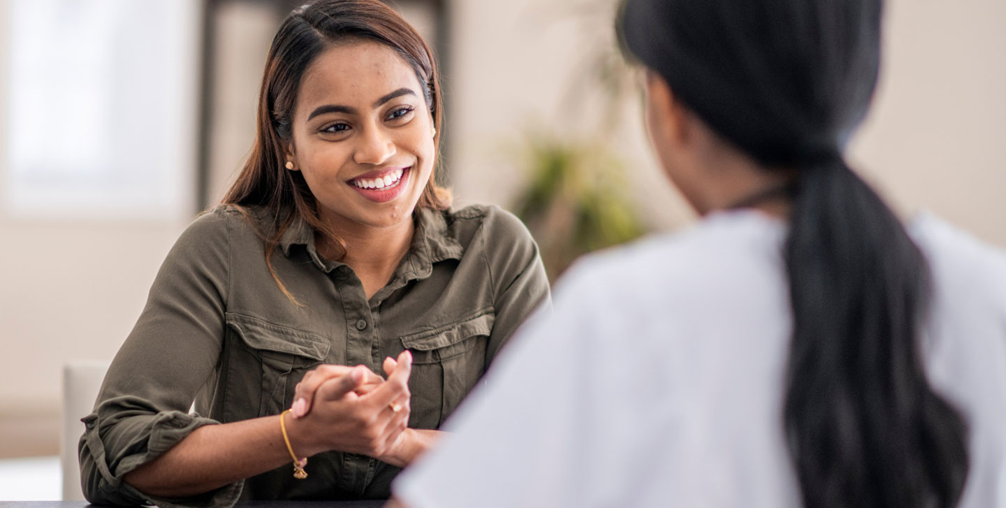 female counselor talking with female student; clinical psychology