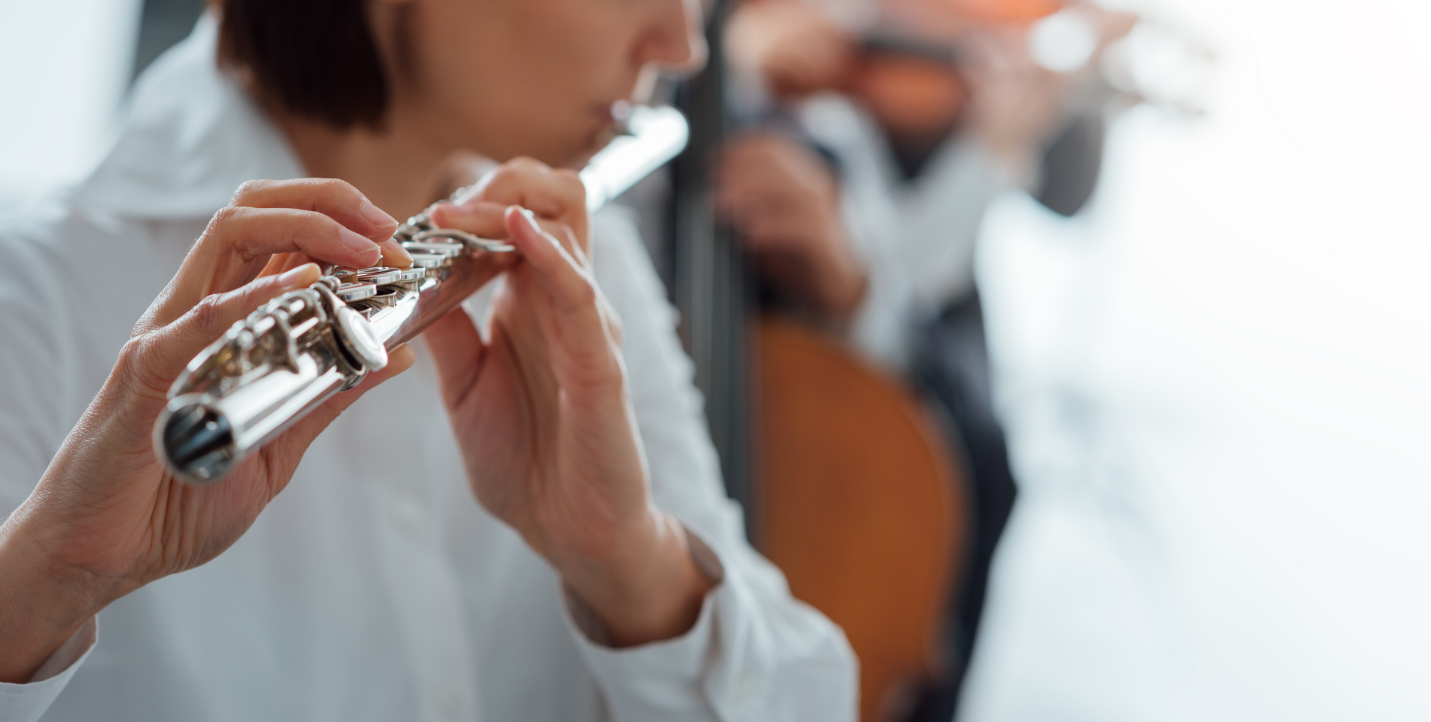 close up of woman playing the flute; music