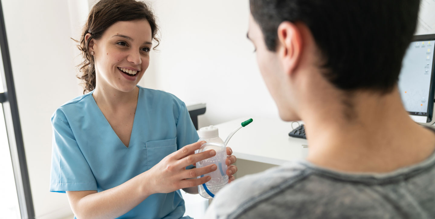 female respiratory therapist handing a patient testing equipment; respiratory therapy