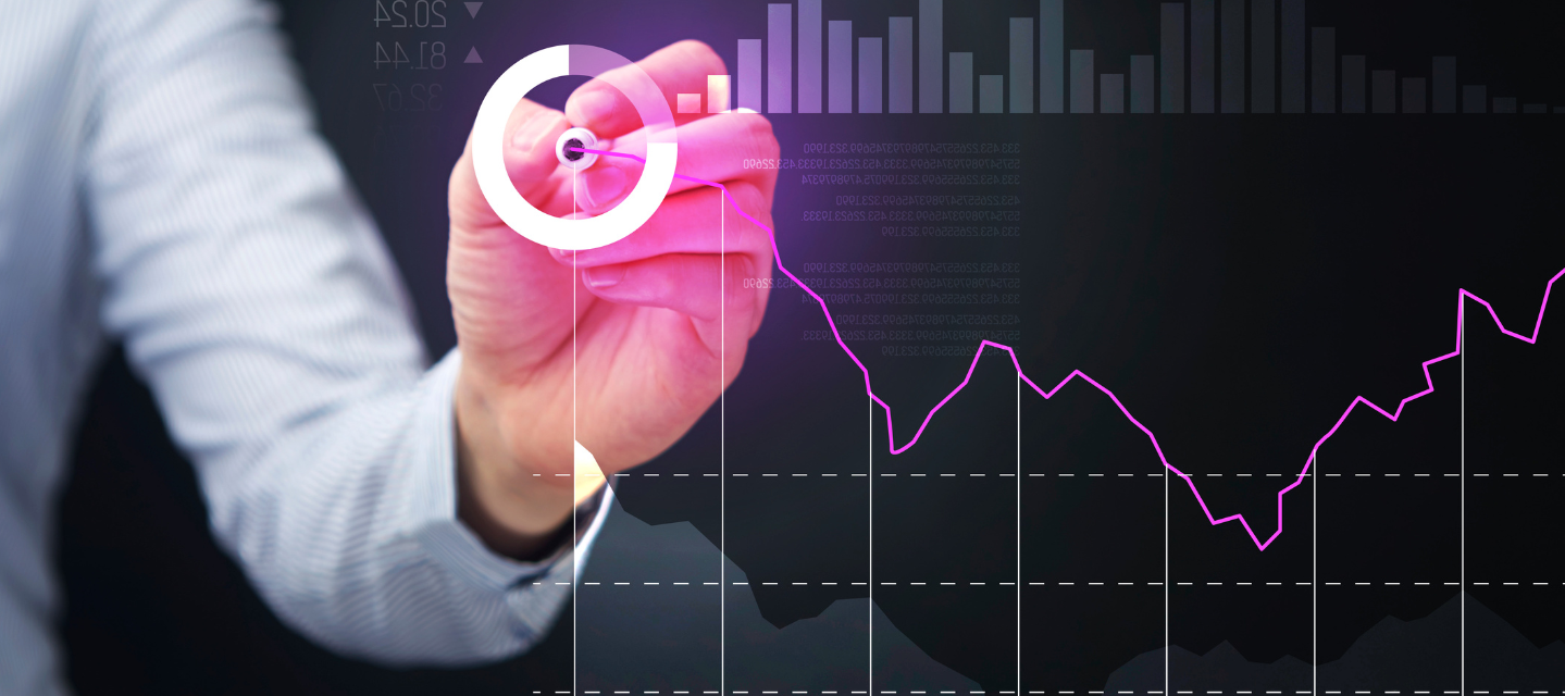 hand with light pen making a graph on a glass screen with business icons on the image; business analytics