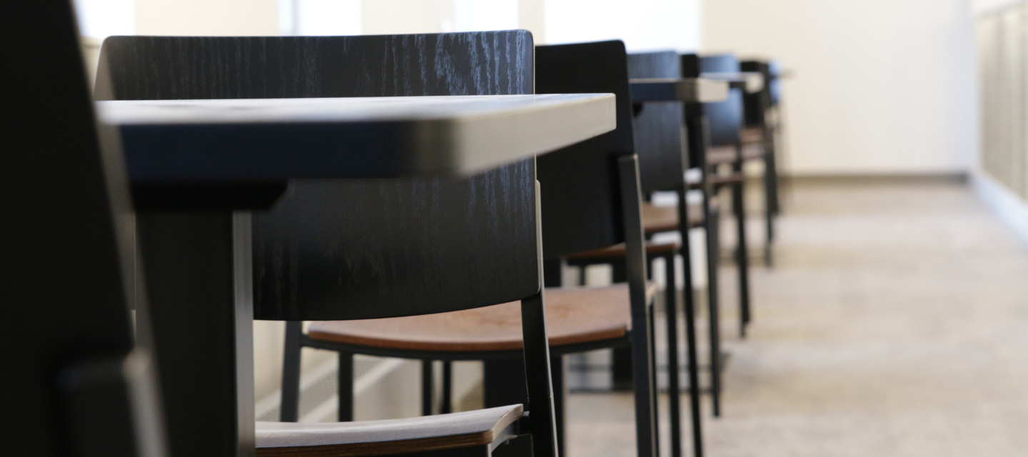 close up photo of a row of desks and chairs