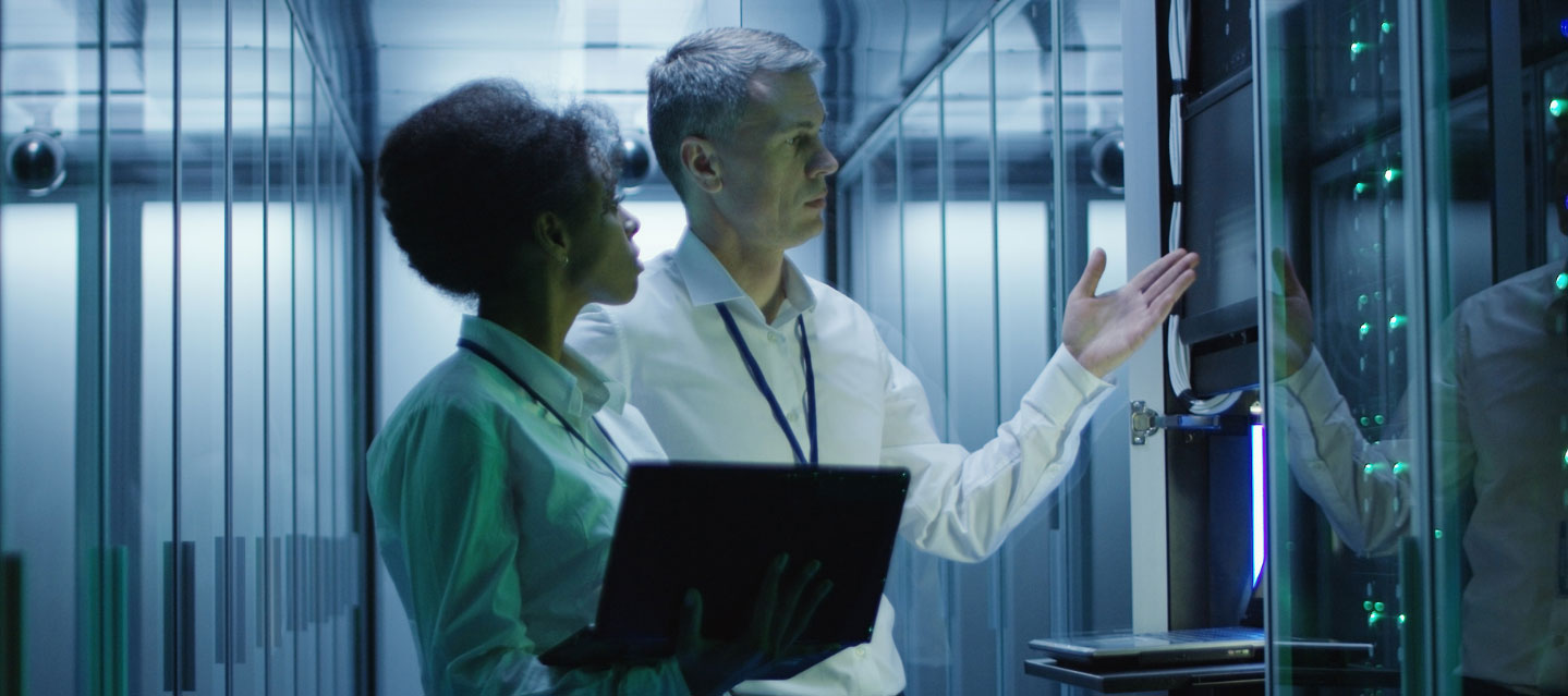 data scientist showing a colleague the computer servers; data science