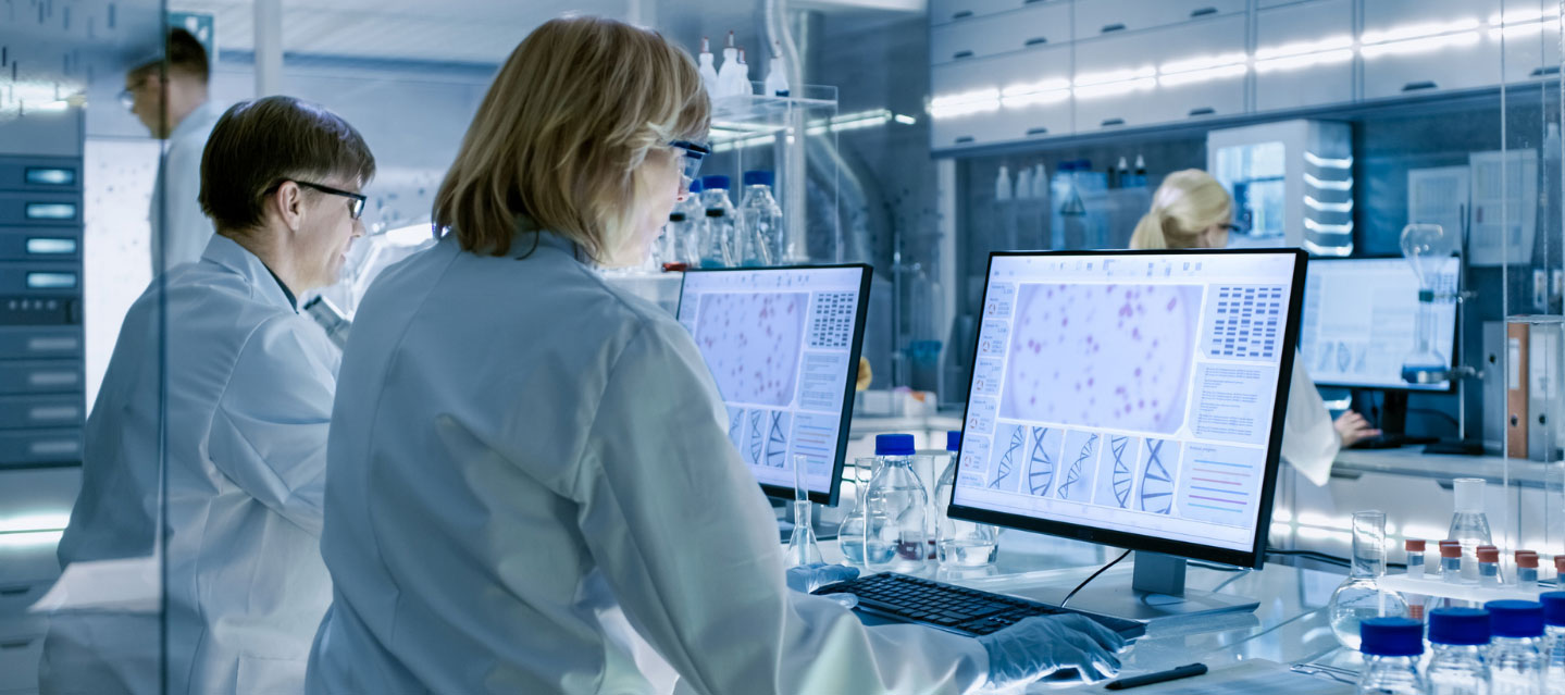 medical technicians looking at images on their monitors; Health science