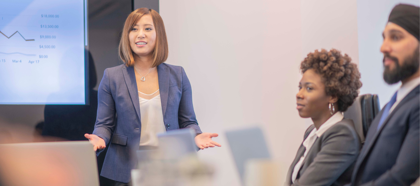 female student presenting to classmates in an international business and economics class