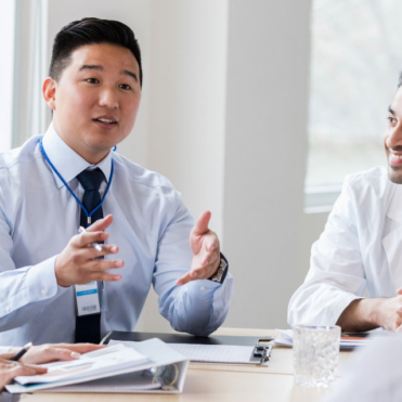 group of medical professionals at the table in a discussion; public health