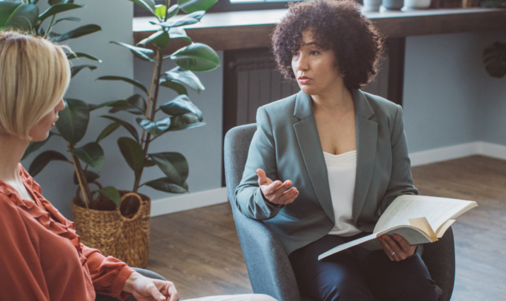 female instructor speaking with student; writing and publishing