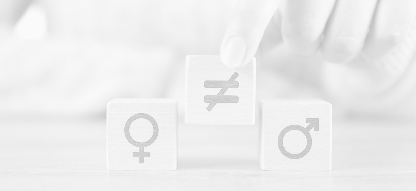 hand placing a wooden block with an "unequal sign" between block with female gender symbol and male gender symbol; gender studies minor