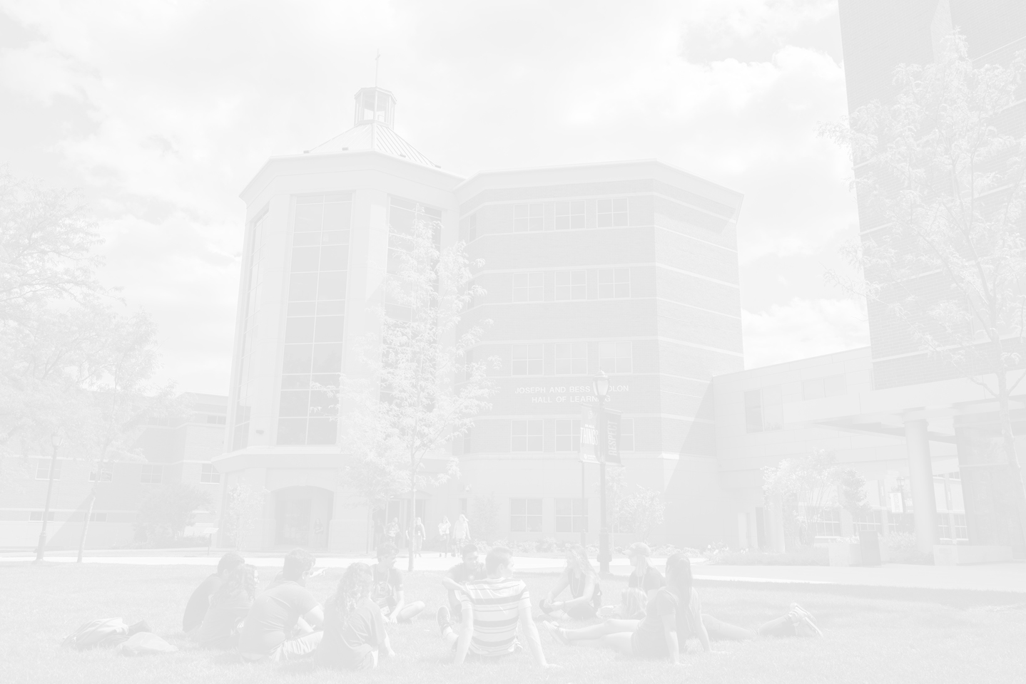 image of Kindlon Hall with students sitting on quad; BenU scholarships