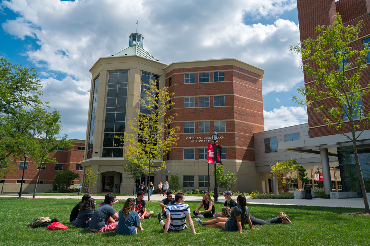 students sitting in circle on BenU quad during Ben Beginnings activities; Benedictine Need Award