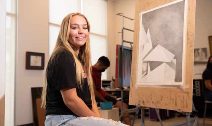 Mesa student in art class, easel, drawing