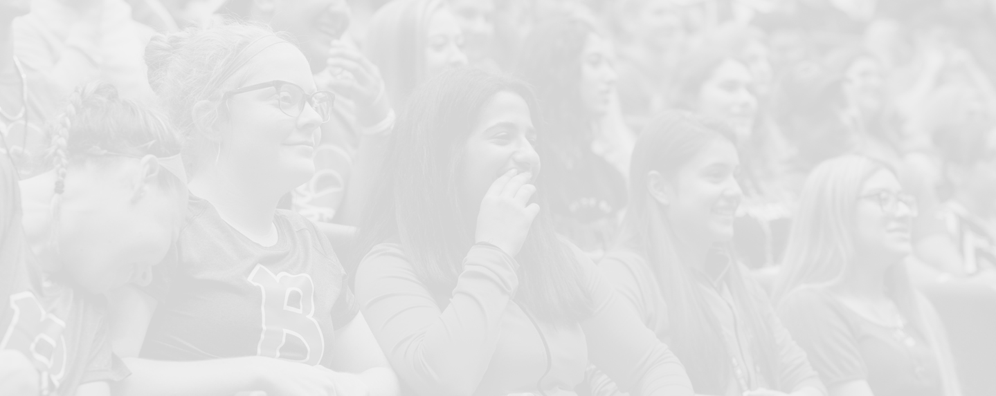 Group of female student sitting in a lecture hall - BenU Advising; photo has white overlay on it